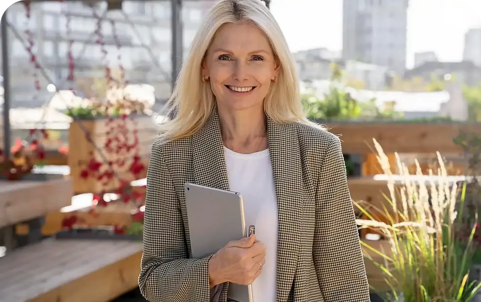 Smiling businesswoman holding tablet outdoors