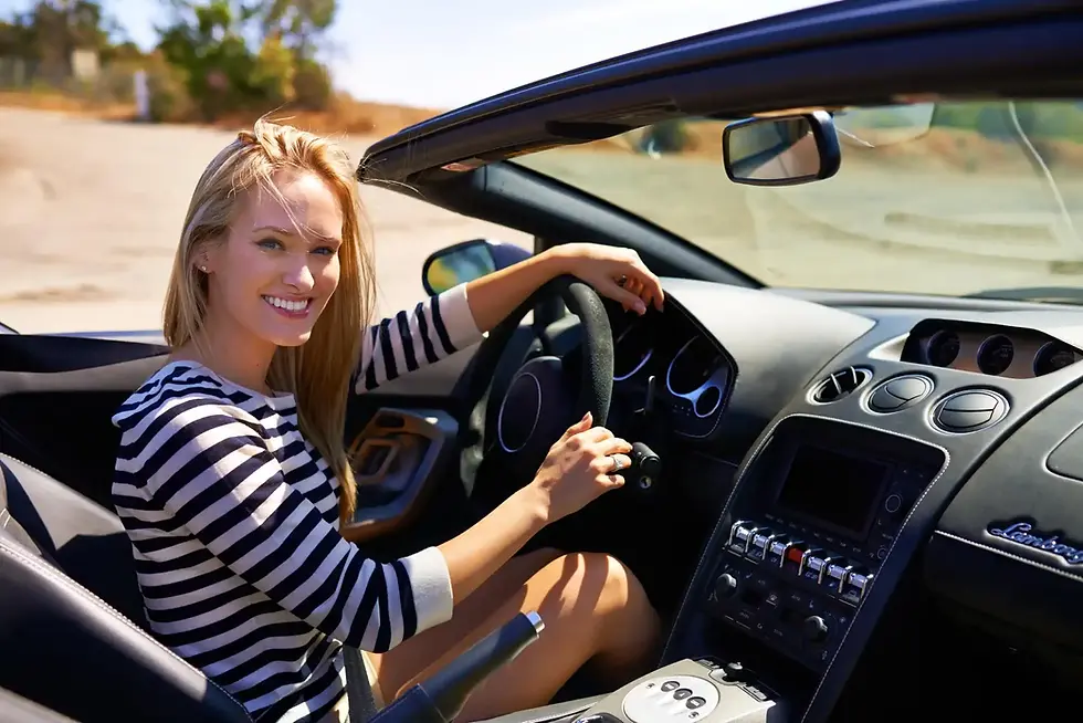 Smiling woman in convertible car