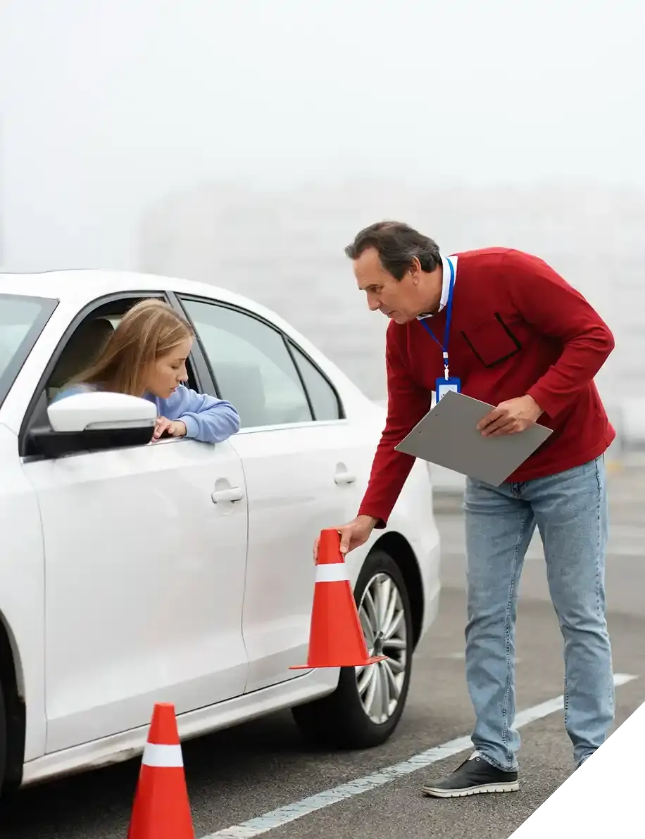 Driving instructor talking to student in car during lesson