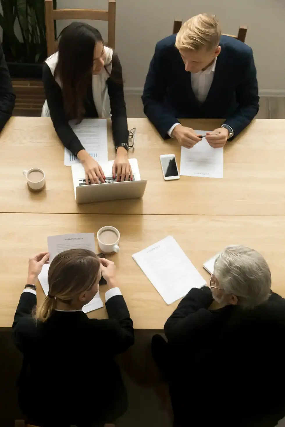 Business team meeting around table, reviewing documents