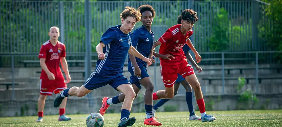 Soccer players in action kicking the ball, green field, sunny day, LilChampFC.