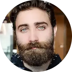 Man with dark beard and light eyes