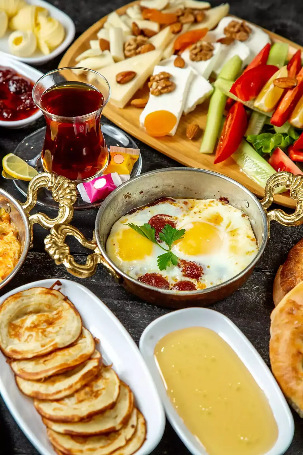 Delicious Turkish breakfast spread: eggs, cheese, bread, and tea