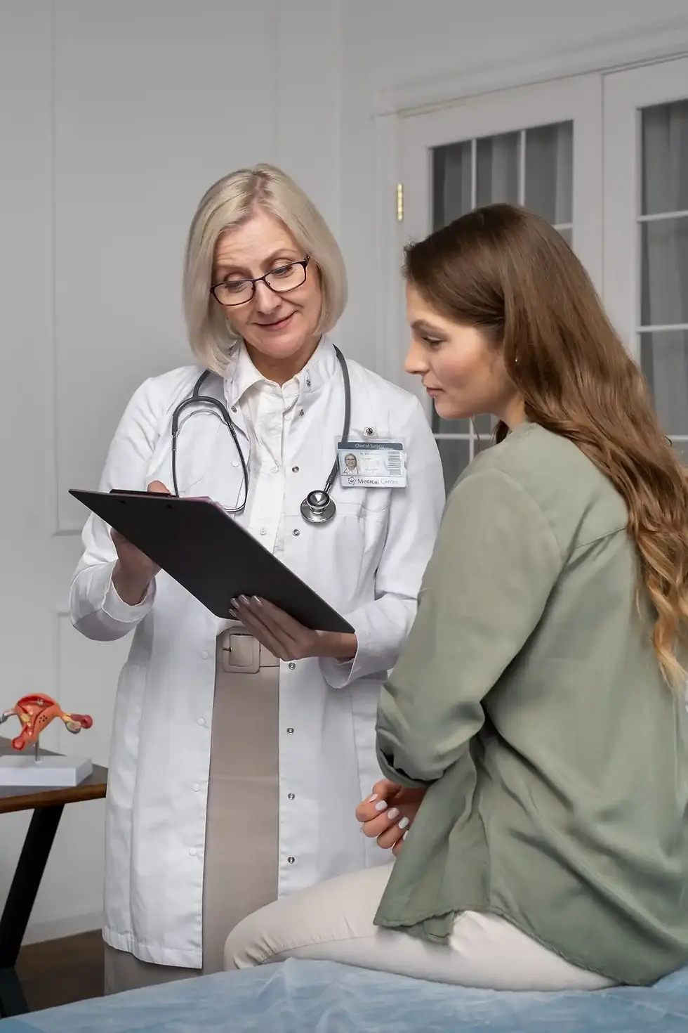 Doctor reviewing patient chart with Astha