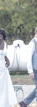 Bride entering the outdoor wedding reception and waving to guests as the celebration begins, captured in a natural documentary wedding photography style.