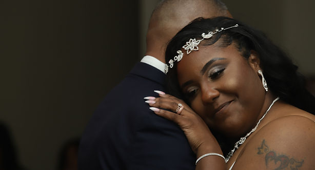 Bride resting her head on her father's shoulder during an emotional father-daughter dance at Tuscany Falls Banquets in Mokena, Illinois.