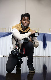 Walking Visions owner kneeling while capturing a wedding, holding his camera during a candid moment