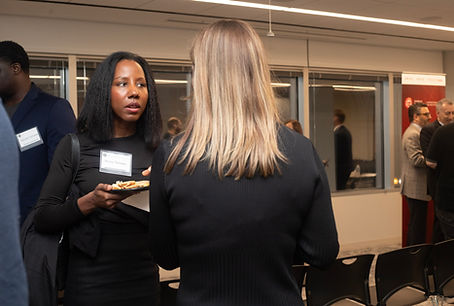 Two women engaged in conversation while holding drinks at a professional networking event hosted by the American Arbitration Association in downtown Chicago at 150 N Michigan Ave.