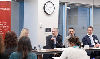 Panelists speaking during a professional conference discussion in Chicago as attendees listen during an educational session.