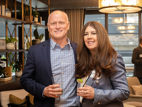 Conference sponsor representatives networking with attendees during a Chicago corporate event reception.