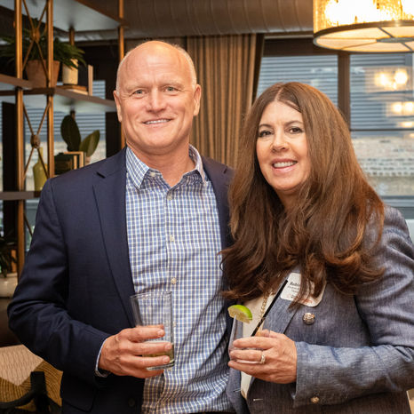 Conference sponsor representatives networking with attendees during a Chicago corporate event reception.