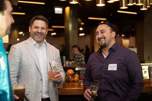 Three men laughing and holding drinks during an In-House Connect networking event at Marshall’s Landing, 222 W Merchandise Mart Plaza, Chicago, IL 60654.