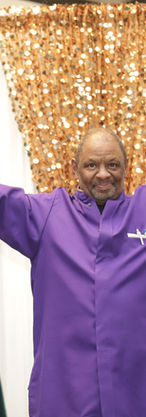 Wedding officiant raising his hands while standing with the two grooms during their Chicago ceremony.