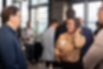 Woman smiling and flipping her hair while networking with attendees during the In-House Connect mixer at Vu Rooftop in Chicago’s South Loop.