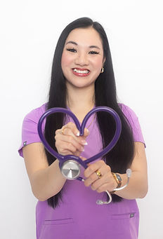 Chicago healthcare professional in purple scrubs forming a heart shape with a stethoscope, smiling in a clean white studio background, medical branding image