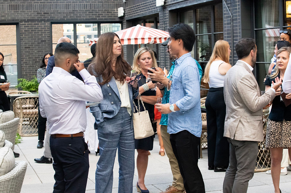Sponsor representatives from Thomson Reuters and Axiom engaging with different attendees during a professional networking event in Chicago