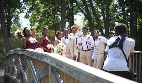 Owner of Walking Visions Photography taking group wedding photos outdoors.