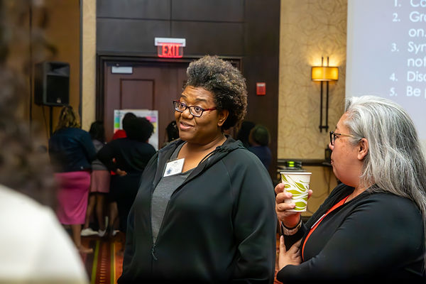 Conference attendees networking and having a discussion during an educational event at a downtown Chicago Marriott photographed by Walking Visions Photography.