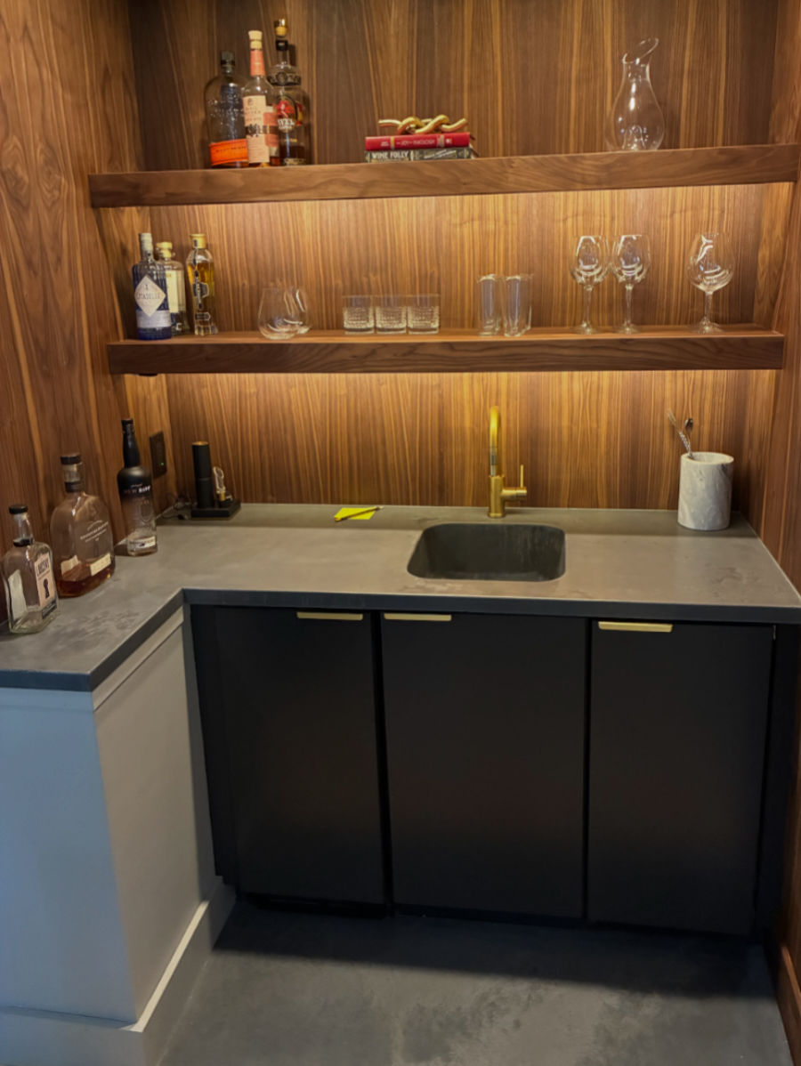 Charcoal concrete bar and floor in a bourbon closet