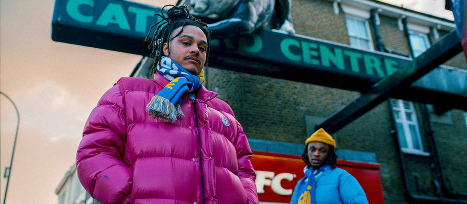 Ryan Hawaii and other male standing under Catford shopping centre cat sculpture