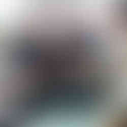 man handing a lady a folded T-shirt