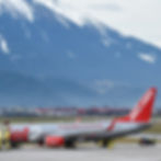 Jet2 Boeing 737 in red and silver livery preparing for departure at Manchester Airport, popular for package holidays.