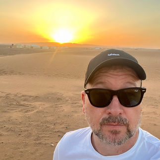 Camel caravan crossing golden dunes in the Sahara Desert, reached using a Jack’s Flight Club travel deal
