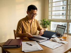 Man reviewing Singapore home sale documents