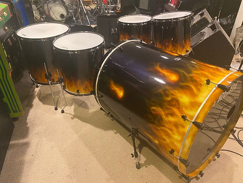 lots of drums with fire design on them