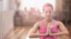 Pregnant mixed race woman meditating on yoga ma