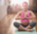 Pregnant mixed race woman meditating on yoga ma