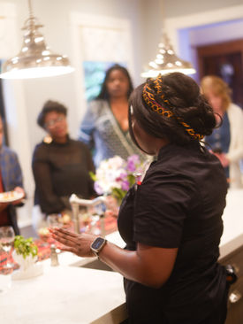 Chef Toya preparing food at a home event
