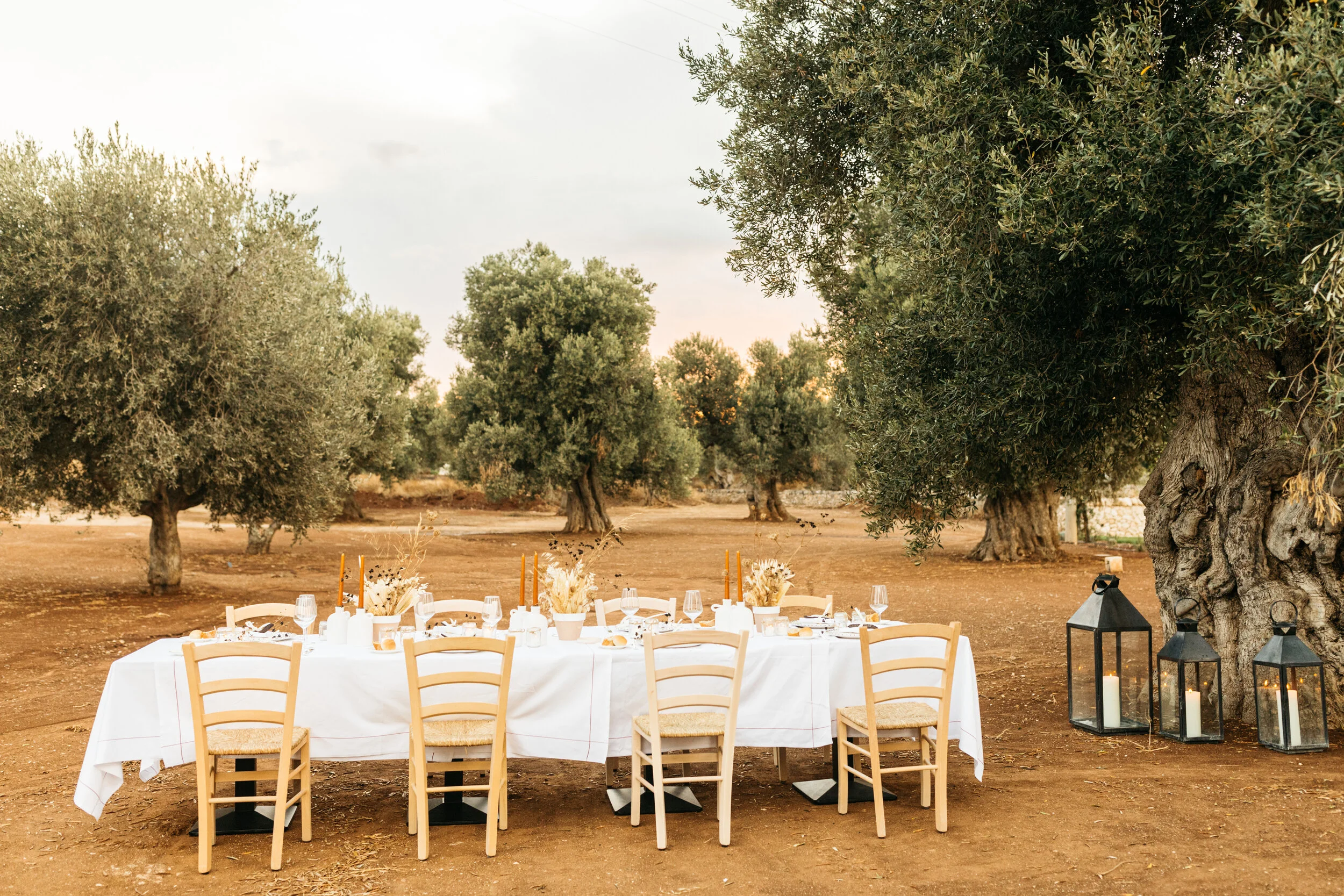 Outdoor dining area at a Puglia masseria with rustic table settings and countryside views