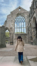 Janet Campbell exploring historic ruins in Europe, inspired by art, history, and the beauty of timeless destinations.