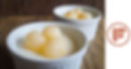 Side view of almond jelly dessert in white ramekins, garnished with canned longans, logo watermark at the side.

