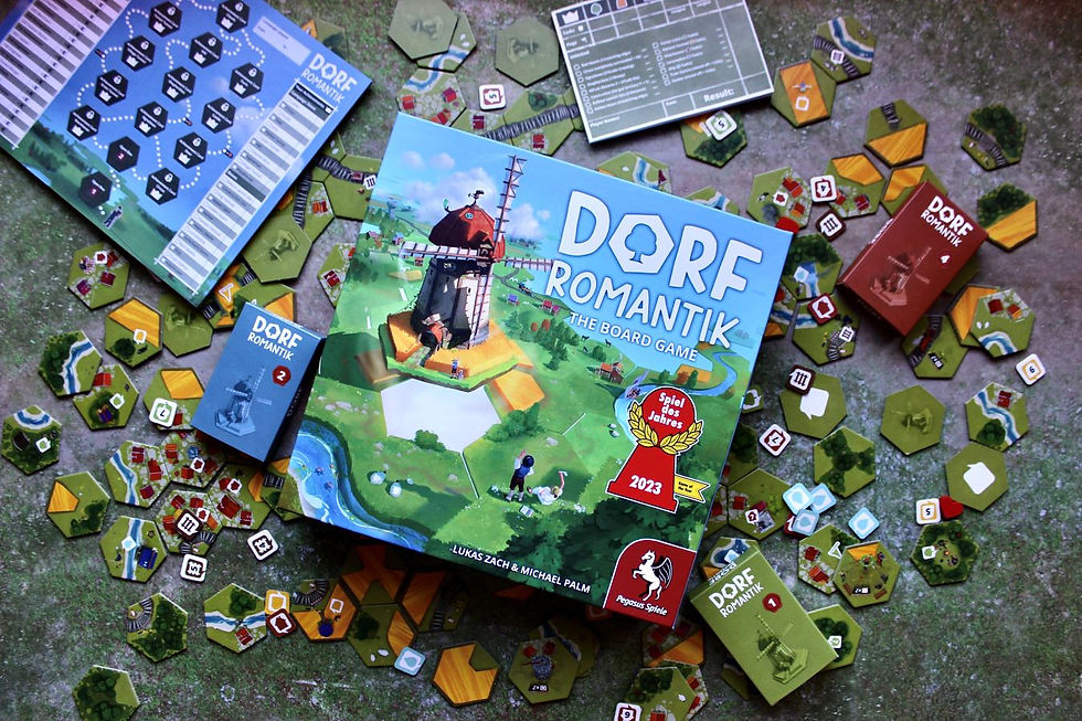 tiles, tokens and other board game components are spread out on a play mat with the Dorfromantik board game box in the center