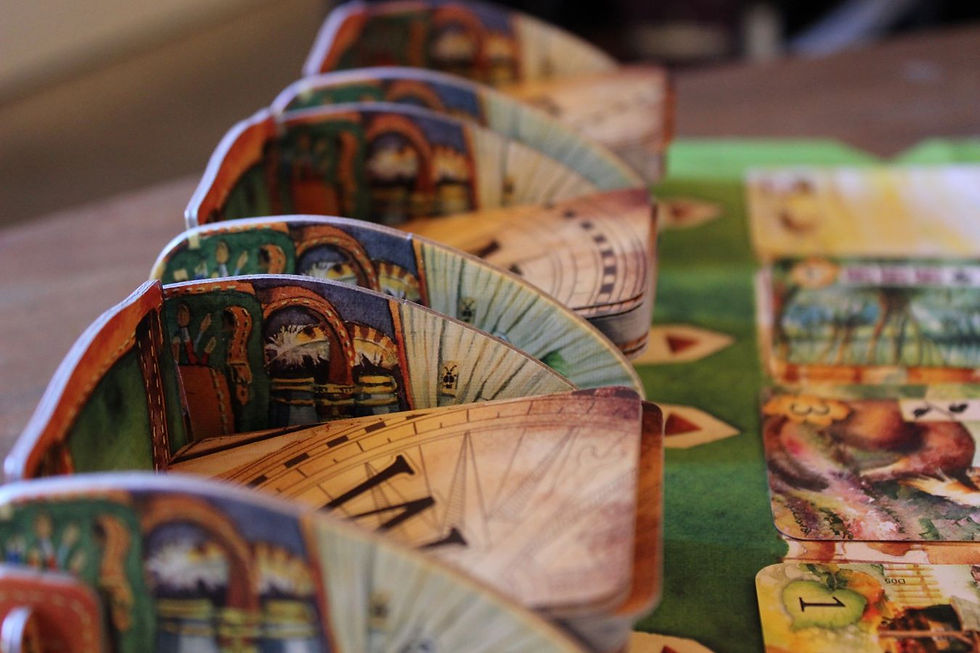 Three detailed colored deck holders contain cards labeled "W" "N" and "E".