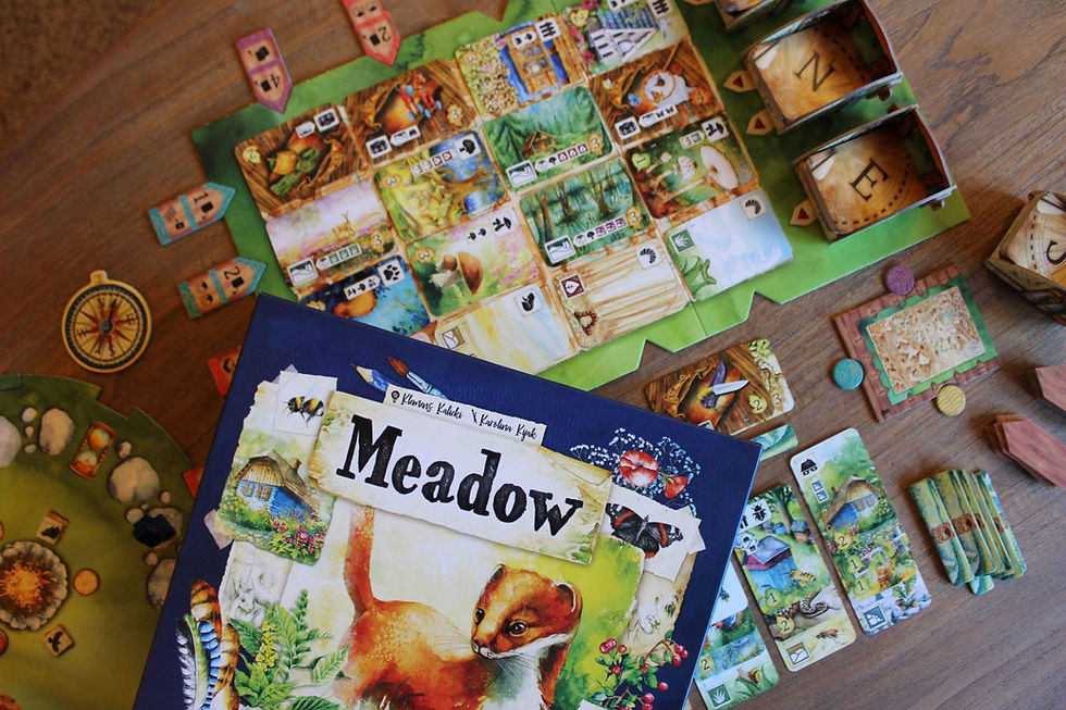 Blue box cover with the word Meadow and a watercolor image of a fox. Cards, tiles, and components.