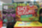Boxed board games including Race to the Treasure and Minecraft Travel Puzzle on a slatwall shelf