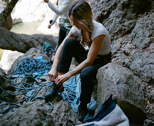 Me lacing up my climbing shoes
