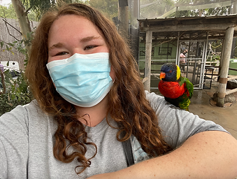 Photo of me with a mask on and a bird on my shoulder.