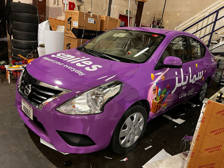 Image of a fleet of vehicles with vibrant and professional Smiles Etisalat branding, showcasing eye-catching graphics and sleek wraps