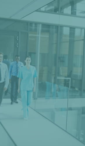 Healthcare professionals walking through a modern healthcare facility