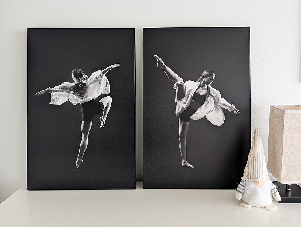 Two black-and-white photos of a dancer in motion hang on a wall. 