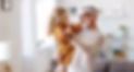 Elegant loving caring grandfather looking at his cute little granddaughter, adorable child