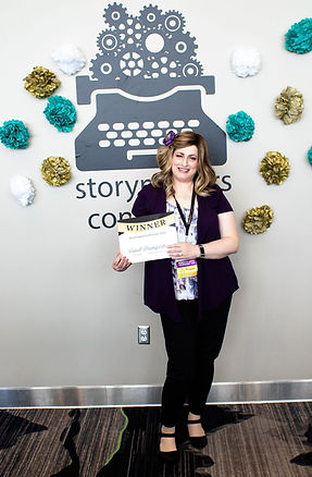 A photo of Soquel holding an award she won at the Storymakers Conference in 2023