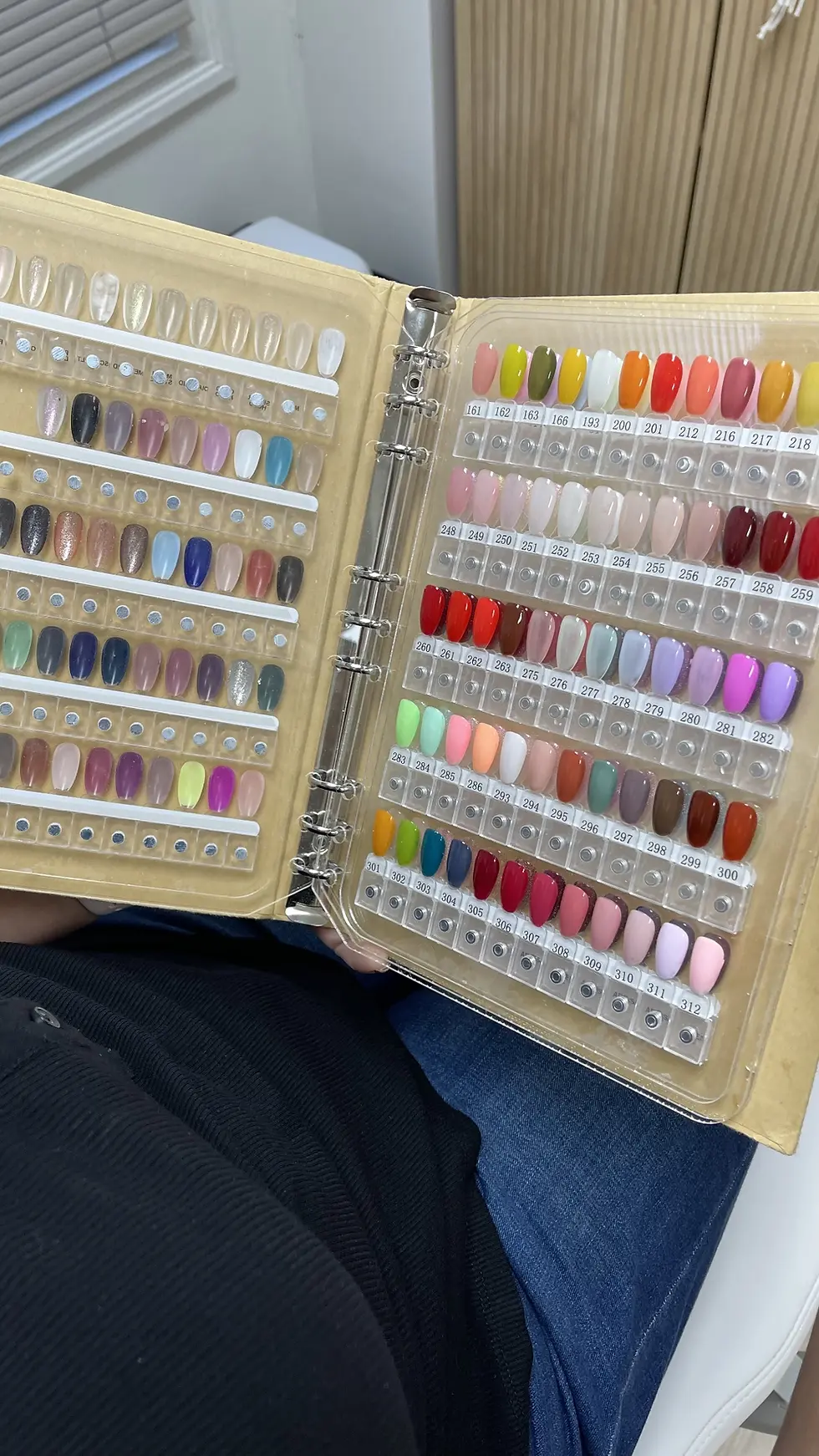 client chooseing gel color for her gel pedicure