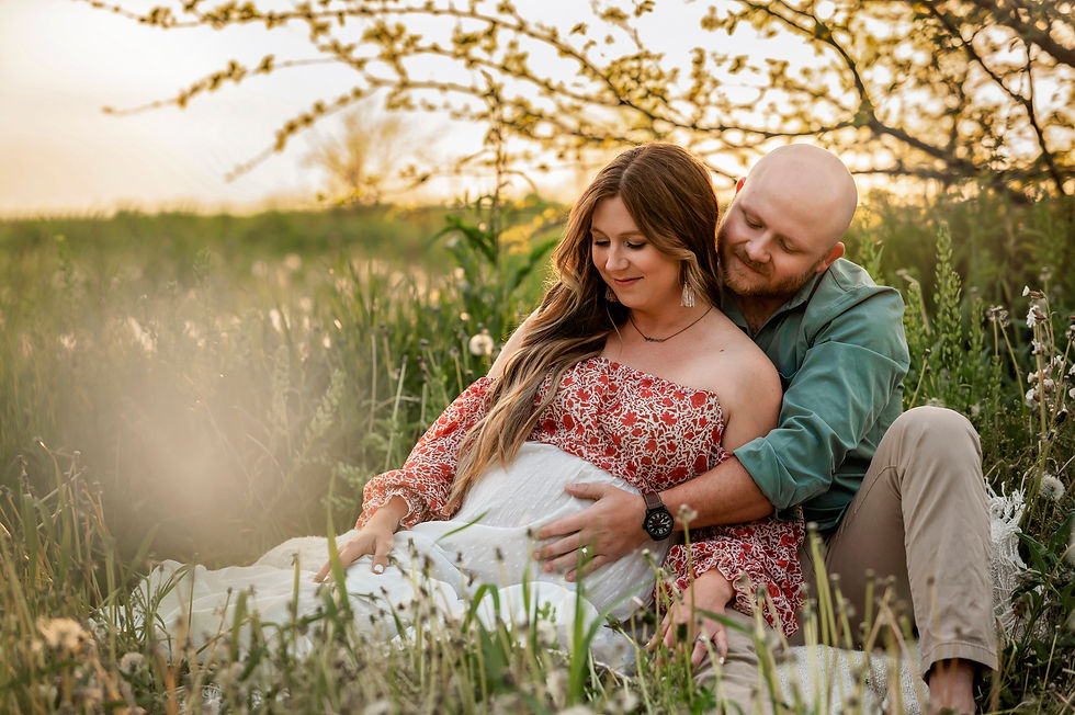 Maternity Photo Session Mother and Father sitting in the grass