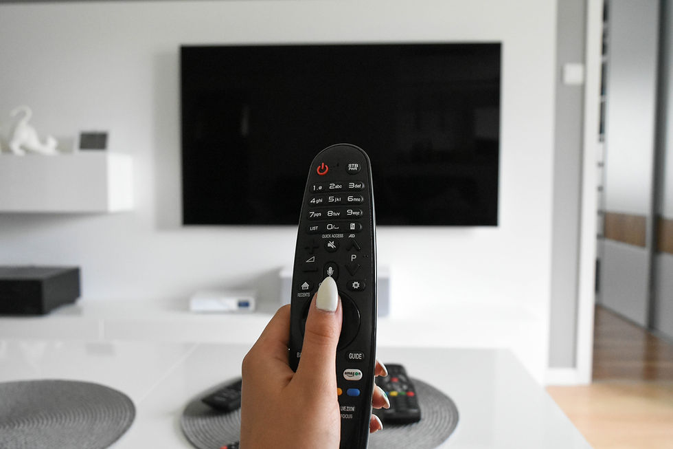someone holding a tv remote and pointing at a blank tv