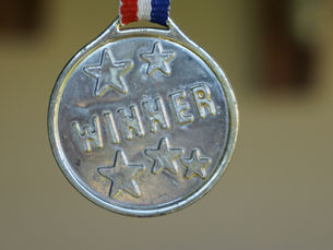 silver medal with the word winner on it 